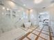 Modern primary bathroom with soaking tub, frameless glass shower, and marble countertops at 17715 Wall Cir, Redington Shores, FL 33708