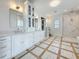 Spacious bathroom with dual vanities, large shower, tub, and stylish lighting at 17715 Wall Cir, Redington Shores, FL 33708