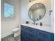 Modern bathroom featuring a walk-in shower and sleek navy blue vanity at 17715 Wall Cir, Redington Shores, FL 33708