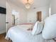 This bedroom is bright and spacious, with a chandelier hanging from the ceiling and a door leading to the hallway at 17715 Wall Cir, Redington Shores, FL 33708
