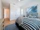 Spacious bedroom with blue and white accents and a view into the hallway at 17715 Wall Cir, Redington Shores, FL 33708