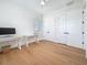 Bright bedroom with light wood floors, two closets with white paneled doors, and natural light from a window at 17715 Wall Cir, Redington Shores, FL 33708