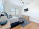 Cozy bedroom with blue accents, a ceiling fan, and a wooden dresser at 17715 Wall Cir, Redington Shores, FL 33708
