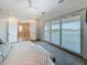 Bright bedroom with water views and large sliding glass doors to a balcony, and an en-suite bathroom at 17715 Wall Cir, Redington Shores, FL 33708