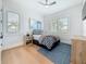 Cozy bedroom with blue accents, two windows, and a wooden dresser at 17715 Wall Cir, Redington Shores, FL 33708