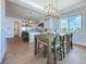 Open-concept dining area with scenic views, adjacent to a modern kitchen with stainless steel appliances at 17715 Wall Cir, Redington Shores, FL 33708
