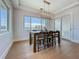 Elegant dining room with a modern chandelier and a large window offering scenic views at 17715 Wall Cir, Redington Shores, FL 33708