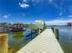 Boat dock with boat and tiki hut offers easy access to the water and relaxation at 17715 Wall Cir, Redington Shores, FL 33708
