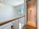 The upstairs landing features a modern railing, a window with a view, and a modern elevator at 17715 Wall Cir, Redington Shores, FL 33708