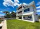 Multi-level home featuring multiple balconies, a waterfront view, and lush landscaping at 17715 Wall Cir, Redington Shores, FL 33708