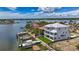 Elegant waterfront home with a private dock, complemented by a neat lawn and clear views of the surrounding waterways at 17715 Wall Cir, Redington Shores, FL 33708
