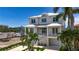 Beautiful two-story home with covered balconies, a three car garage, and meticulous landscaping at 17715 Wall Cir, Redington Shores, FL 33708