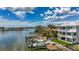 Waterfront home boasting a private boat dock, well-maintained lawn, and picturesque water views under a bright sky at 17715 Wall Cir, Redington Shores, FL 33708