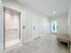 Well-lit foyer with elevator access, complemented by shiplap walls and light-colored flooring for a modern touch at 17715 Wall Cir, Redington Shores, FL 33708