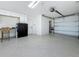 Spacious garage with epoxy floors, storage cabinets, and an attached workspace at 17715 Wall Cir, Redington Shores, FL 33708