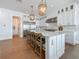 Open kitchen layout with a large island, pendant lighting, stainless steel appliances, and white cabinetry at 17715 Wall Cir, Redington Shores, FL 33708