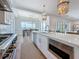 Spacious kitchen with an island, stainless steel appliances, pendant lighting, and access to the dining area at 17715 Wall Cir, Redington Shores, FL 33708