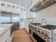 Modern kitchen with stainless steel appliances, chevron backsplash, and white cabinets offering ample storage at 17715 Wall Cir, Redington Shores, FL 33708