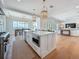 Modern kitchen with island seating, stainless steel appliances, and an adjacent dining area at 17715 Wall Cir, Redington Shores, FL 33708
