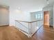 The upstairs landing features a modern railing, a window with a view, and an elevator at 17715 Wall Cir, Redington Shores, FL 33708