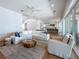 Open concept living room with white furniture and adjacent kitchen with island seating at 17715 Wall Cir, Redington Shores, FL 33708