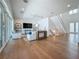 A spacious living room with hardwood floors and a large window with a view at 17715 Wall Cir, Redington Shores, FL 33708