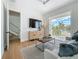 Bright living room with balcony access, modern furnishings, and scenic views of the neighborhood at 17715 Wall Cir, Redington Shores, FL 33708