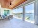 Inviting covered patio with ample seating, overhead wood ceiling and expansive waterfront views at 17715 Wall Cir, Redington Shores, FL 33708