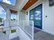 Inviting outdoor porch with stylish railings, a ceiling with wooden panels and glass doors at 17715 Wall Cir, Redington Shores, FL 33708