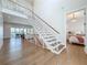 Open staircase with modern railing design, and a view into the bedroom and main living area at 17715 Wall Cir, Redington Shores, FL 33708