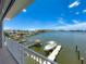 Beautiful waterfront view showcasing the boat dock with lift, tiki hut, and surrounding coastal neighborhood at 17715 Wall Cir, Redington Shores, FL 33708