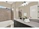 Elegant bathroom featuring a modern vanity, soaking tub, and separate shower, perfect for relaxation and functionality at 2120 Gwynhurst Blvd, Wesley Chapel, FL 33543