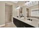 Bathroom featuring double sinks, quartz countertops, a soaking tub, and a glass shower at 2120 Gwynhurst Blvd, Wesley Chapel, FL 33543