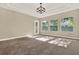 Sunlit bedroom with neutral colors, carpet, and a modern light fixture at 2120 Gwynhurst Blvd, Wesley Chapel, FL 33543