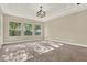 Spacious bedroom featuring a tray ceiling, three large windows, and neutral-toned walls at 2120 Gwynhurst Blvd, Wesley Chapel, FL 33543
