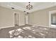 Bright bedroom with tray ceiling, large windows and an open door at 2120 Gwynhurst Blvd, Wesley Chapel, FL 33543