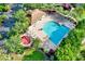 Aerial view of a community pool, play area, lounge chairs, and clubhouse at 2120 Gwynhurst Blvd, Wesley Chapel, FL 33543