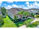 Well-maintained home with stone accents, mature landscaping, green lawn, and two-car garage at 2120 Gwynhurst Blvd, Wesley Chapel, FL 33543