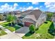 Beautiful single-Gathering home showcasing manicured landscaping, stone accents, and a two-car garage at 2120 Gwynhurst Blvd, Wesley Chapel, FL 33543