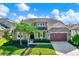 Stunning home with stone accents, lush landscaping, well-manicured lawn, and a two-car garage at 2120 Gwynhurst Blvd, Wesley Chapel, FL 33543