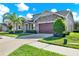 Inviting home with stone accents, manicured lawn and landscaping, plus a two-car garage at 2120 Gwynhurst Blvd, Wesley Chapel, FL 33543