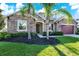 Beautiful stone-accented home with manicured landscaping, green grass, and a two-car garage at 2120 Gwynhurst Blvd, Wesley Chapel, FL 33543