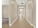 Hallway with tile floors, neutral paint, and archways leading to other rooms at 2120 Gwynhurst Blvd, Wesley Chapel, FL 33543