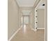 Inviting hallway with tiled flooring, arched entryways, and a front door view at 2120 Gwynhurst Blvd, Wesley Chapel, FL 33543
