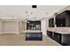 Open-concept kitchen with black cabinets, a large island, and stainless steel appliances at 2120 Gwynhurst Blvd, Wesley Chapel, FL 33543