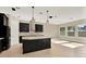 Modern kitchen with black cabinets, a large island, and lots of natural light at 2120 Gwynhurst Blvd, Wesley Chapel, FL 33543