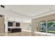 Open-concept kitchen with dark cabinetry, stainless appliances and lots of natural light at 2120 Gwynhurst Blvd, Wesley Chapel, FL 33543