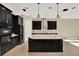 Elegant kitchen with black cabinets, a large island with light countertops, and brick backsplash at 2120 Gwynhurst Blvd, Wesley Chapel, FL 33543