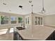 Modern kitchen island with stone countertops and stainless steel sink and faucet fixtures at 2120 Gwynhurst Blvd, Wesley Chapel, FL 33543