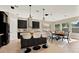 Modern eat-in kitchen featuring black cabinets, a large island, and stainless steel appliances at 2120 Gwynhurst Blvd, Wesley Chapel, FL 33543
